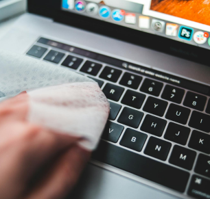 person cleaning keyboard